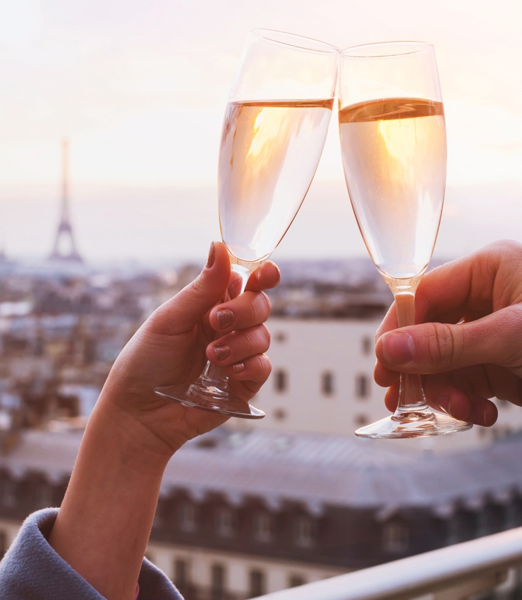 Couple toasting champagne classes in Paris