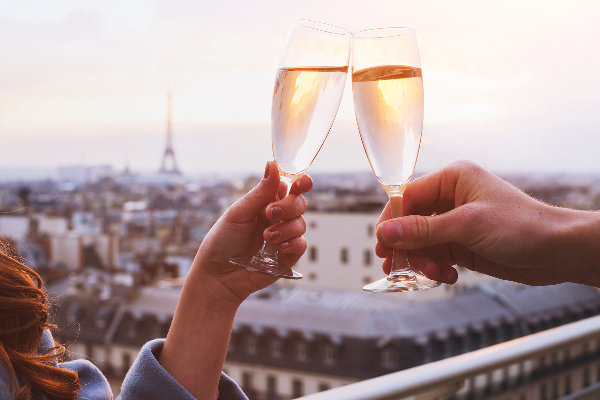 Couple toasting champagne classes in Paris