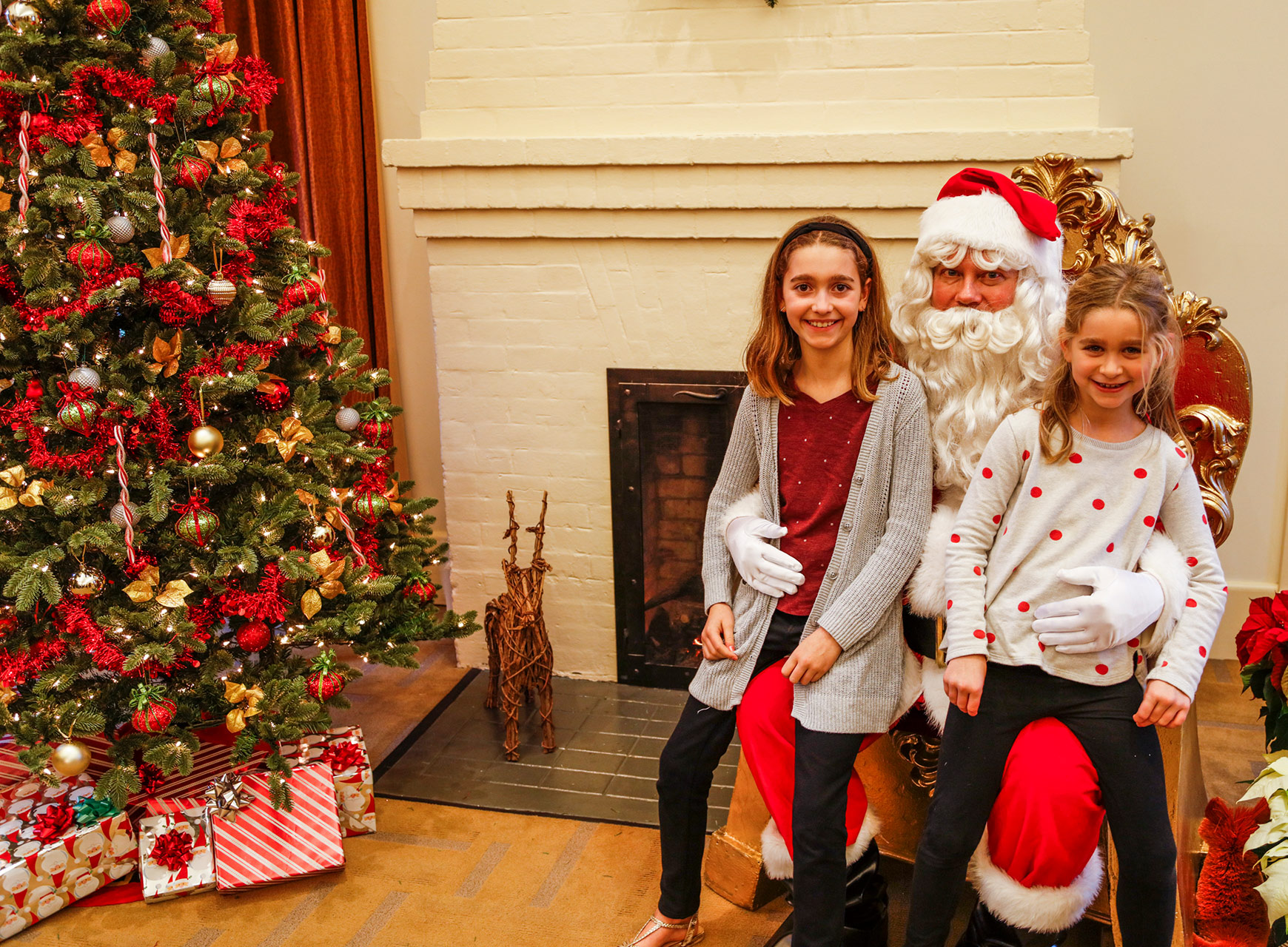 kids sitting on santa claus' lap